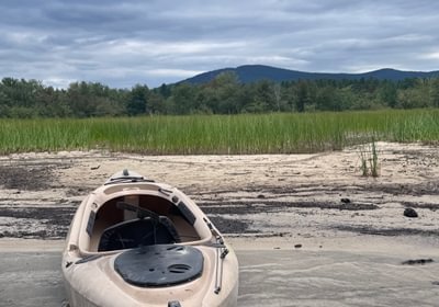 227 Kayak on beach with Pleasant Mountain