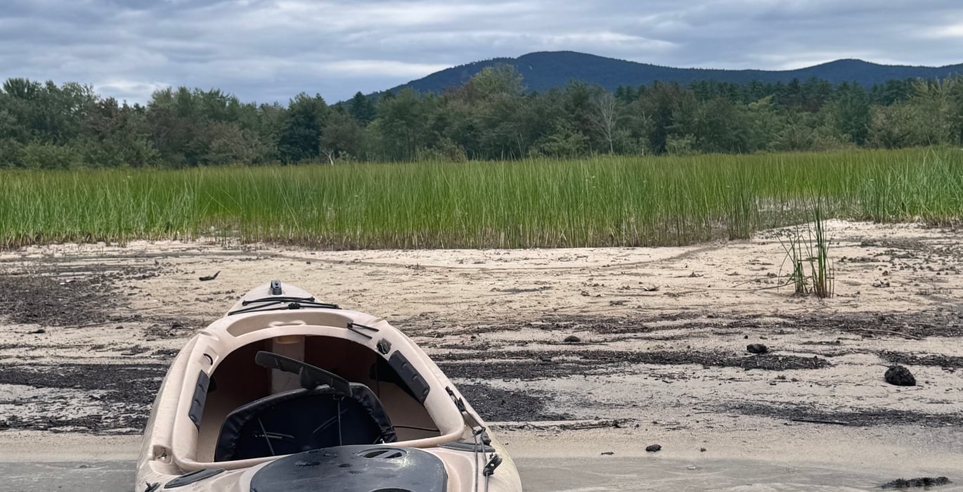 227 Kayak on beach with Pleasant Mountain