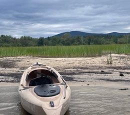 227 Kayak on beach with Pleasant Mountain